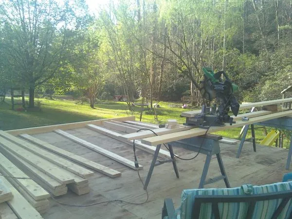 Miter saw and framing lumber on a deck under construction in Fort Belvoir